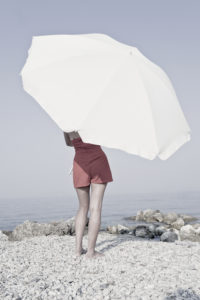 Corfu, girl on the beach with beach umbrella Corfu, girl on the beach with beach umbrella
